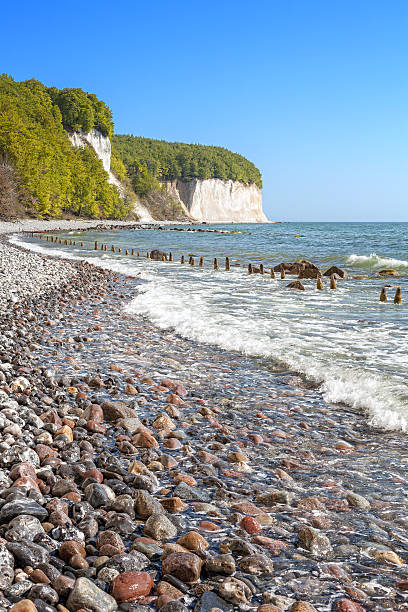 istock Beach with stones and chalk cliffs in distance. 530935104