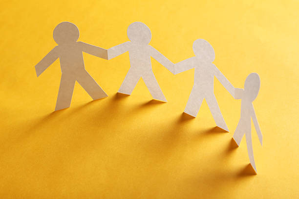 istock Paper people on the orange paper background 530935904