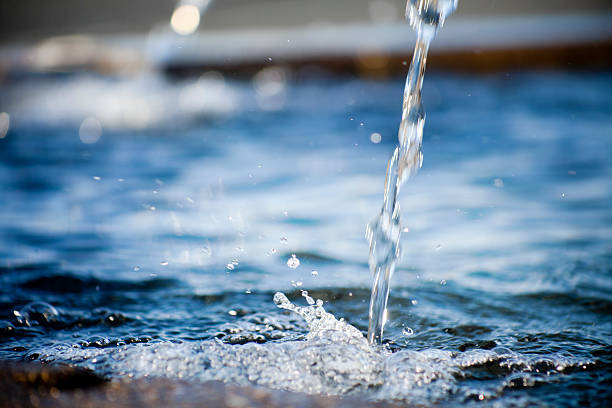 Water fountain, two spurts and water surface. stock photo