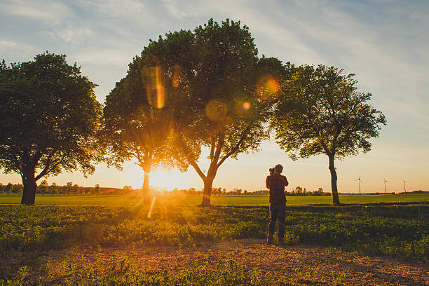 istock Man photographing at sunset in nature 530937432