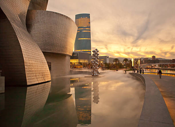 Bilbao, Spain, , November 8, 2012. you can see the sunset of the Guggenheim Museum of Contemporary Art, designed by Frank O. Gehry. and the background the tower iberdrola