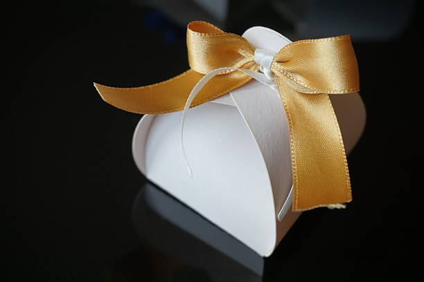 istock Small papery gift box with  golden ribbon on the top 530940556