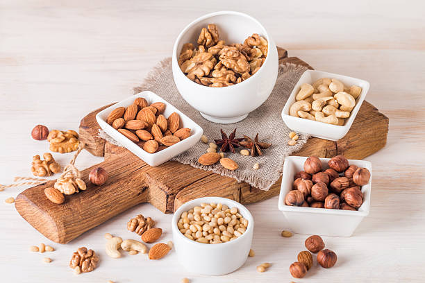 istock almonds, walnuts, hazelnuts cashews and pine nuts in wooden bowl 530942616