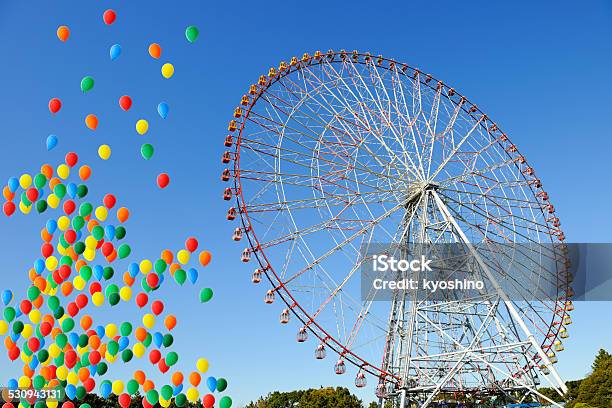 Ferris Wheel With Multicolored Balloons Moving Up In Clear Sky Stock Photo - Download Image Now