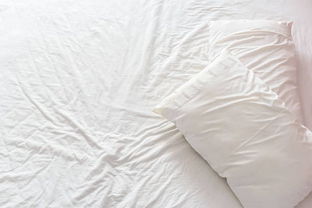 istock Top view of an untidy / unmade bed with bedsheet 530943750
