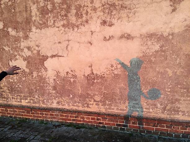 istock Shadow of a child playing with a soccer ball 530944898