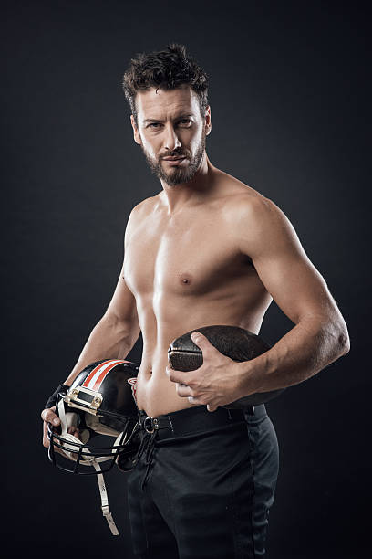 istock Shirtless football player with helmet 530945348