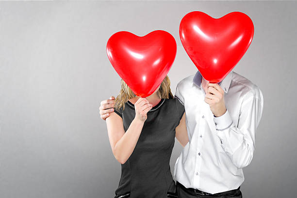 istock happy couple with balloons instead of a head 530946449