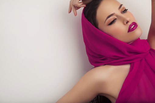 beautiful woman portrait with scarf and makeup, studio white