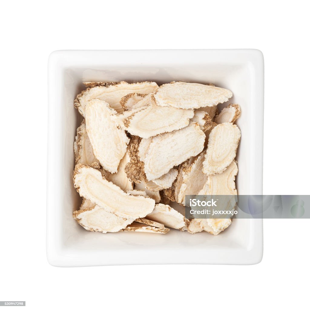 Traditional Chinese Medicine - Sliced ginseng (Panax ginseng) Traditional Chinese Medicine - Sliced ginseng in a square bowl isolated on white background Ginseng Stock Photo