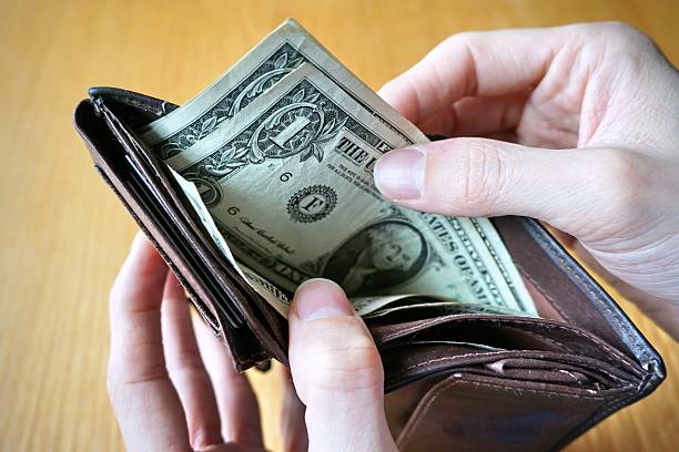 istock Male hand withdrawing American currency (US Dollars) from wallet 530947812