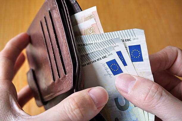 istock Male hand withdrawing European currency (EUR, Euro) from wallet 530947954