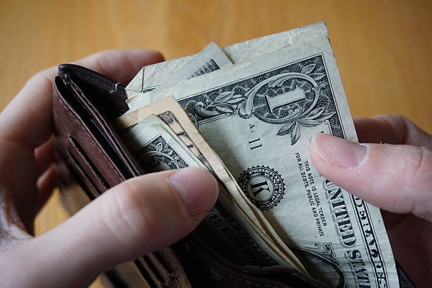 istock Male hand withdrawing American currency (US Dollars) from wallet 530948068