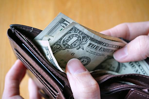 istock Male hand withdrawing American currency (US Dollars) from wallet 530948106