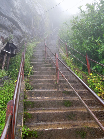 foggy scenery including a stairway to a mountain in Sri Lanka named Adam´s Peak