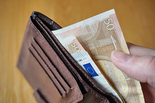 istock Male hand withdrawing European currency (EUR, Euro) from wallet 530948186