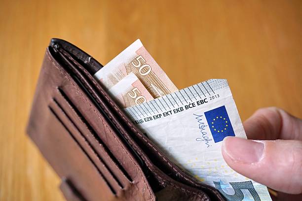 istock Male hand withdrawing European currency (EUR, Euro) from wallet 530948222