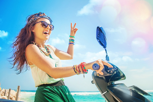 stylish selfie on a beach while riding a motorbike