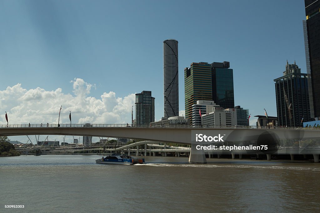 Brisbane River A photograph of some high rise buildings in Brisbane, on the Brisbane River, taken on a sunny day with some fluffy white clouds. Brisbane is the capital and most populous city in the Australian state of Queensland, and the third most populous city in Australia. Brisbane's metropolitan area has a population of 2.24 million, and the South East Queensland urban conurbation, centred on Brisbane, encompasses a population of more than 3 million. The Brisbane central business district stands on the original European settlement and is situated inside a bend of the Brisbane River, approximately 15 kilometres (9 miles) from its mouth at Moreton Bay. The metropolitan area extends in all directions along the floodplain of the Brisbane River valley between Moreton Bay and the Great Dividing Range. Apartment Stock Photo