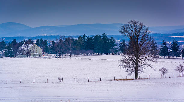 istock View of snow-covered farm fields and distant mountains from Long 530960095