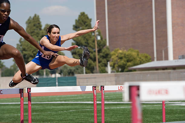 istock Female athletes hurdling 530961553