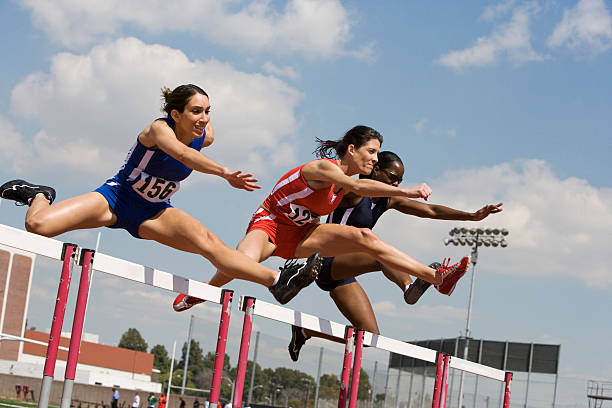 istock Female athletes hurdling 530961565