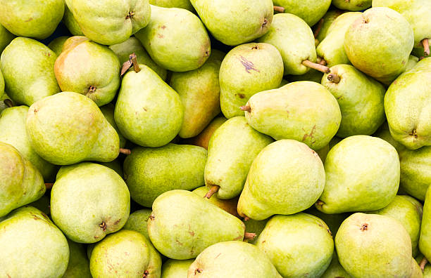 Bartlett pears on display Freshly picked green Bartlett pears on display at the farmer's market bartlett pear stock pictures, royalty-free photos & images