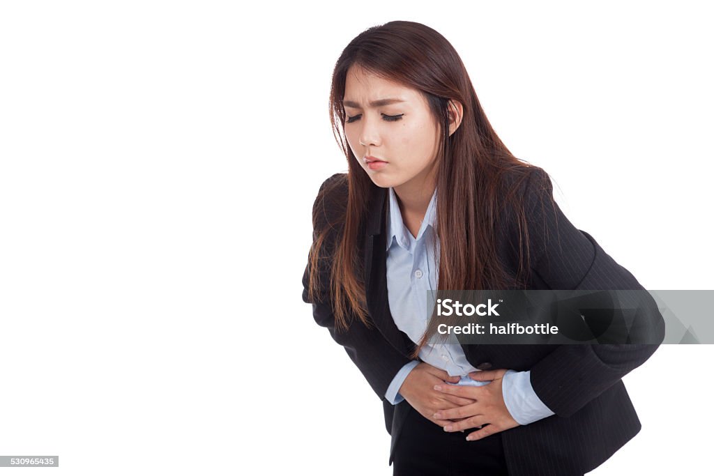 Young Asian businesswoman got  stomachache Young Asian businesswoman got  stomachache isolated on white background 2015 Stock Photo