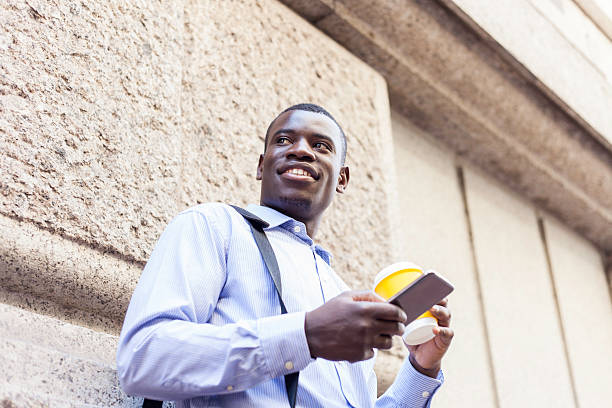 istock African businessman sending a text, looking around. 530969555