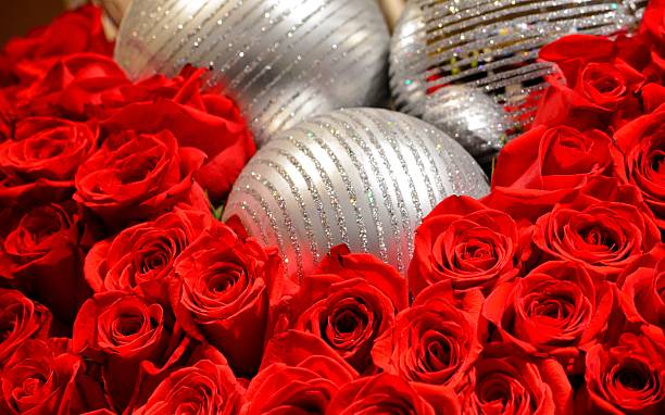 Holiday Ornaments and Red Roses stock photo