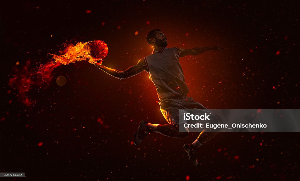 Professional basketball player with fireball Professional basketball player is shoting the fireball Activity Stock Photo