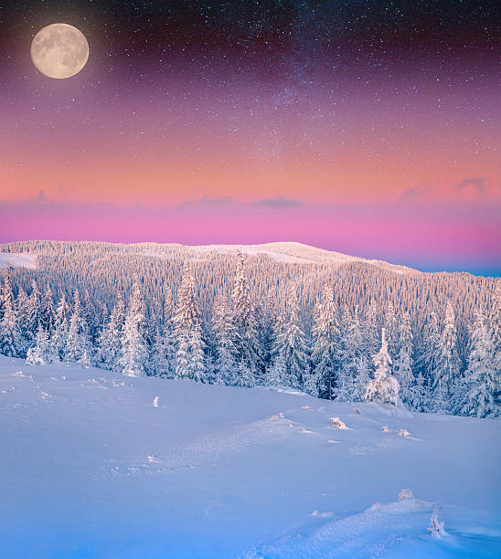 istock Rising moon over frosty winter mountains. 530975507