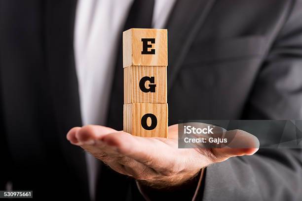 Businessman Holding Wooden Alphabet Blocks Reading Ego Stock Photo - Download Image Now