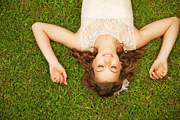 istock Beautiful  woman lying on the grass with her eyes closed 530975879