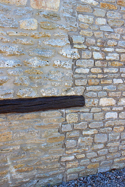 istock Barn-conversion house wall, re-pointed old bricks, new home-improvement extension, wooden-beam 530979853