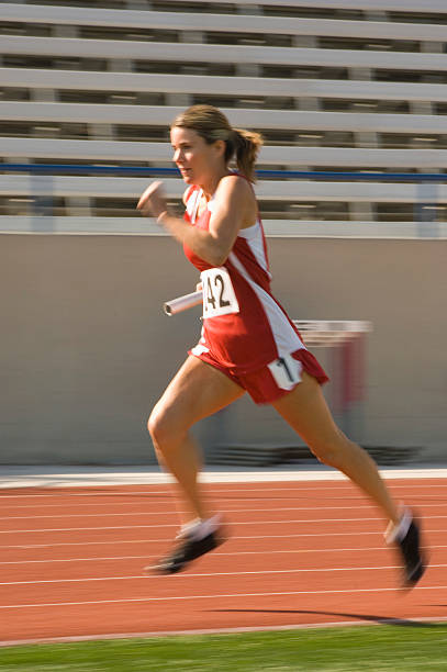 istock Female track athlete sprinting 530980207