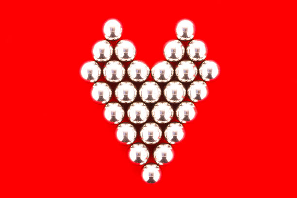 Steel ball beautiful red heart on the scene.