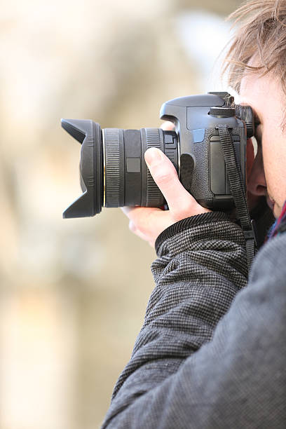 istock Photographer taking a photo with a digital SLR camera 530982347