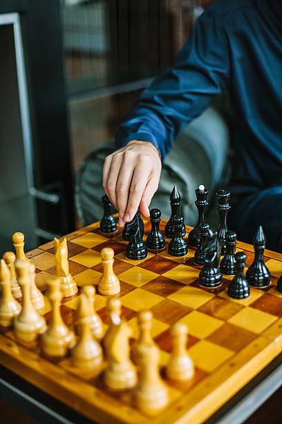 istock Man in business suit playing chess inside the room. 530983832