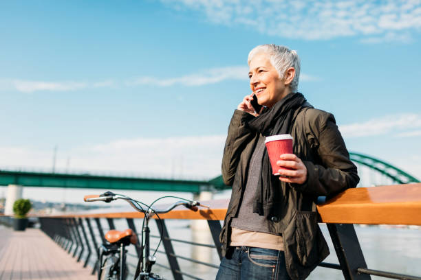 istock Mature Woman Talking On The Phone And Drinking Coffee. 530983982