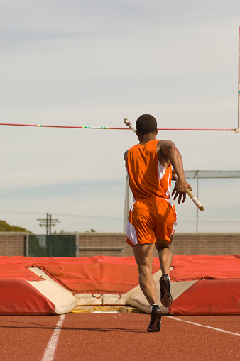 Pole-vaulter running with pole