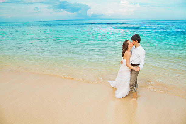 istock Bride and groom kissing on the beach 530985665