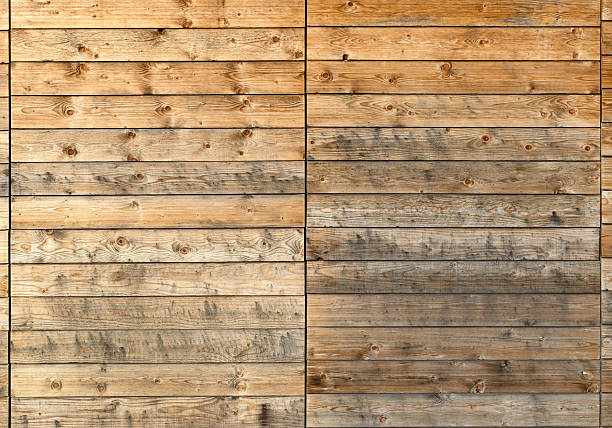Close up of a strongly dirty wooden facade of horizontal, broad boards 