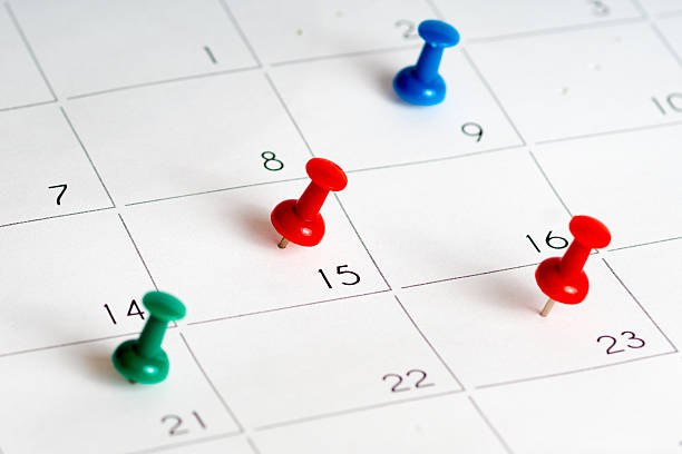 istock green red blue pins on calendar grid 530986134