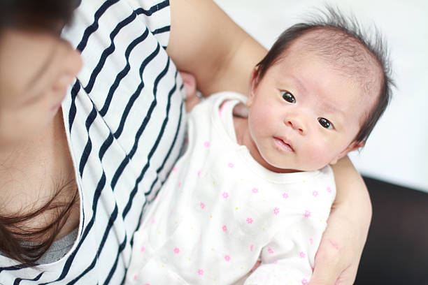 istock Newborn baby held by her mother (Japanese baby girl) 530987177