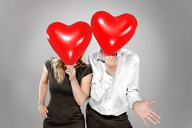 istock couple with balloons instead of a head 530987343