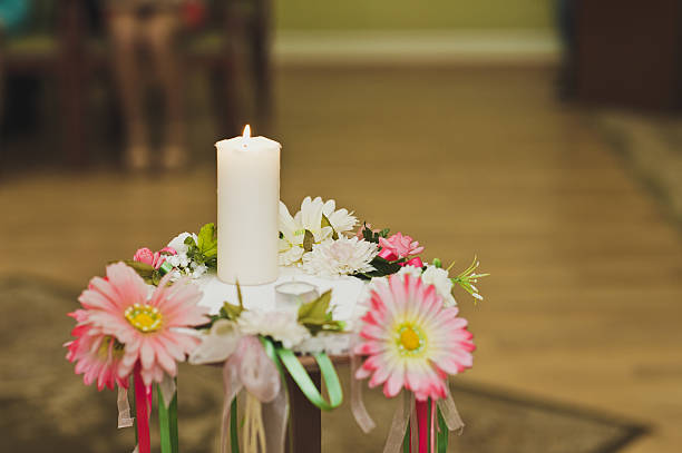 istock Burning candle on a stand surrounded by candles 530987516