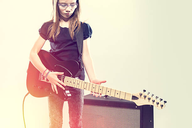 istock Girl Playing Electric Guitar 530987640