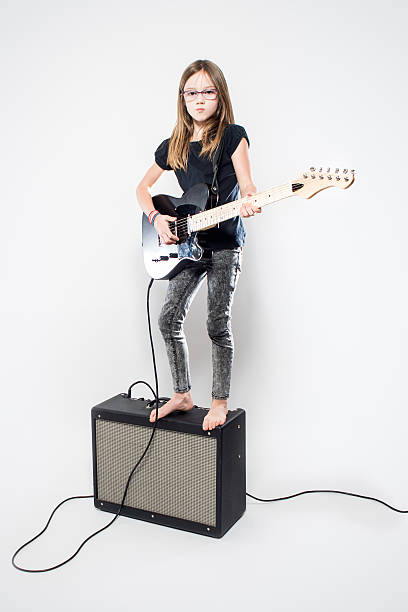 istock Girl Playing Electric Guitar 530988410