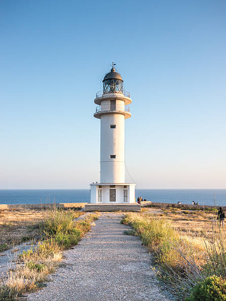 Sunset at the Lighthouse Barbaria lighthouse seen on a sunny sunset in Formentera, Spain formentera island stock pictures, royalty-free photos & images